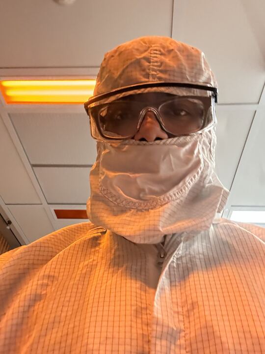Girish in a full cleanroom gown, hood, and safety glasses